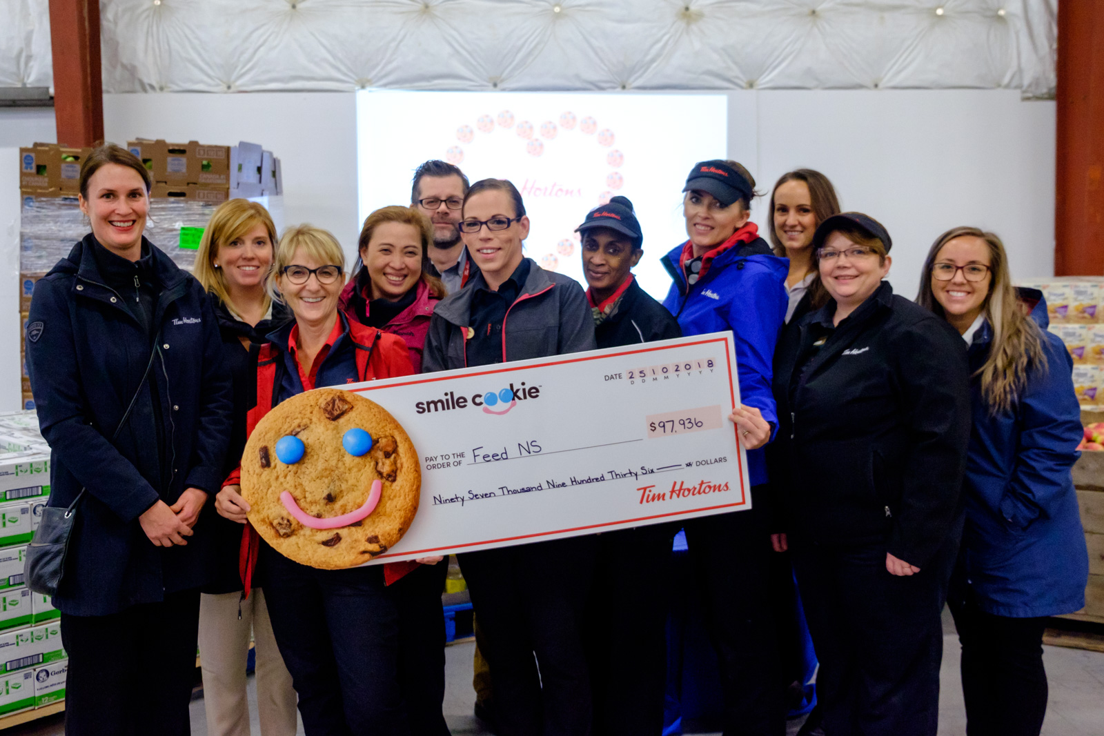 Tim Hortons staff with a big cheque from the Smile Cookie campaign